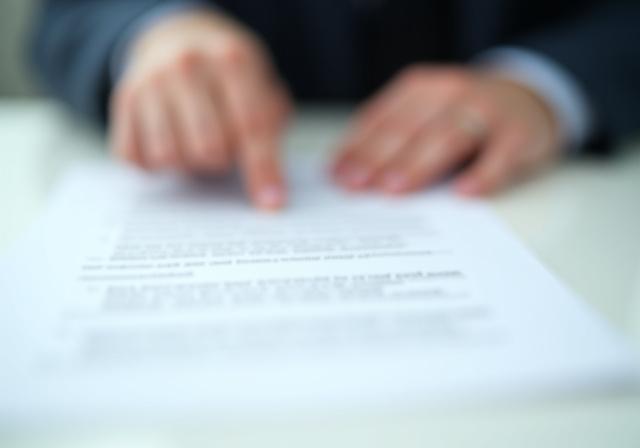 Legal professional reviewing documents in a sophisticated office